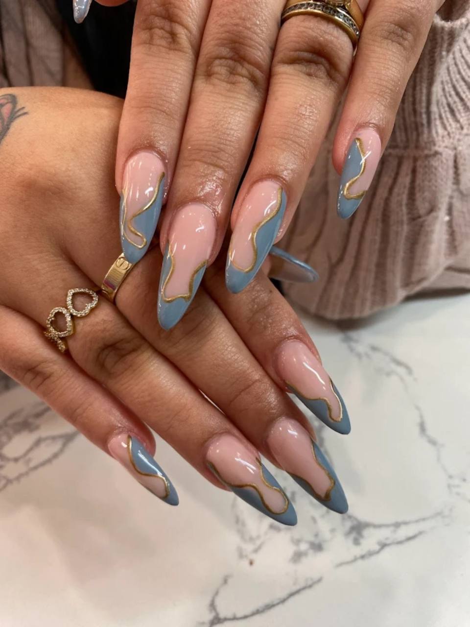 Blue and gold contour nail design.