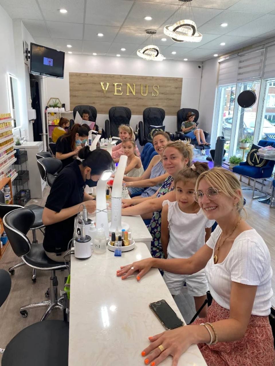 Salon technician working at a manicure station.