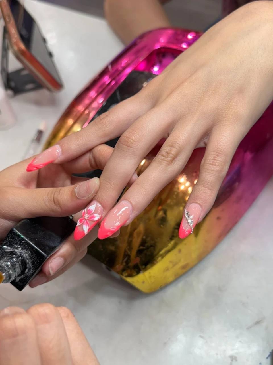 Nail technician removing polish.